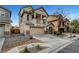 Two-story house with a balcony, two-car garage, desert landscaping, and a spacious driveway at 5829 Feral Garden St, North Las Vegas, NV 89031