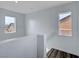 Bright hallway features a smooth white wall, luxury vinyl flooring, and two windows at 5829 Feral Garden St, North Las Vegas, NV 89031