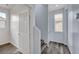 Hallway with wooden floors, showcasing the architectural details leading to other rooms at 5829 Feral Garden St, North Las Vegas, NV 89031
