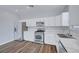 Bright kitchen boasts stainless steel appliances, white cabinets, and stylish countertops at 5829 Feral Garden St, North Las Vegas, NV 89031