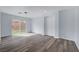 A bright living room with sliding glass doors and luxury vinyl plank flooring at 5829 Feral Garden St, North Las Vegas, NV 89031