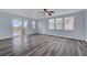 Spacious living room with balcony access and large windows overlooking neighborhood at 5829 Feral Garden St, North Las Vegas, NV 89031