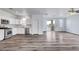 Open-concept living space with a modern kitchen and access to a private outdoor balcony at 5829 Feral Garden St, North Las Vegas, NV 89031