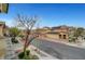Street view of homes with desert landscaping, solar panels and mountain views at 5829 Feral Garden St, North Las Vegas, NV 89031