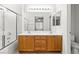 Bathroom featuring double sinks, a large mirror, and a tiled shower with glass doors at 6037 Soft Springs Ave, Las Vegas, NV 89130