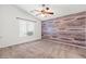 Bedroom showcasing a wood accent wall and a ceiling fan with a light fixture at 6037 Soft Springs Ave, Las Vegas, NV 89130