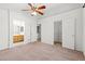 Bedroom with a wood accent wall, ceiling fan, and a door to an en suite bathroom at 6037 Soft Springs Ave, Las Vegas, NV 89130