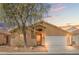 Charming single-story home with desert landscaping and a two-car garage under a colorful sunset at 6037 Soft Springs Ave, Las Vegas, NV 89130