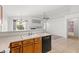 Open kitchen area featuring oak cabinets, modern appliances, and tiled flooring at 6037 Soft Springs Ave, Las Vegas, NV 89130