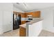 Bright kitchen featuring oak cabinets, black appliances, and tiled flooring at 6037 Soft Springs Ave, Las Vegas, NV 89130