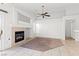 Bright living room featuring neutral tile, fireplace, ceiling fan and sliding glass door at 6037 Soft Springs Ave, Las Vegas, NV 89130