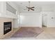 Bright living room featuring neutral tile, fireplace, ceiling fan and natural light at 6037 Soft Springs Ave, Las Vegas, NV 89130