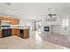 Bright, open-concept living area with tile floors, fireplace, and adjacent kitchen at 6037 Soft Springs Ave, Las Vegas, NV 89130