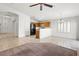 Bright open living area featuring fireplace, ceiling fan and adjacent kitchen at 6037 Soft Springs Ave, Las Vegas, NV 89130
