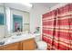 Bathroom featuring a single sink vanity, toilet, and red-striped shower curtain at 6066 El Sol Dr, Las Vegas, NV 89142