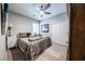 Cozy bedroom with neutral walls, a ceiling fan, shuttered windows and a well-made bed at 618 Steep Canyon Ave, Las Vegas, NV 89183