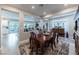 Open-concept dining room featuring a wood table, decorative rug, and seamless flow to the living spaces at 618 Steep Canyon Ave, Las Vegas, NV 89183