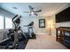 A home gym with various fitness equipment, a ceiling fan, and a mounted TV at 618 Steep Canyon Ave, Las Vegas, NV 89183