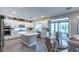 Bright kitchen with white cabinets, island, stainless steel appliances, and sliding door at 618 Steep Canyon Ave, Las Vegas, NV 89183