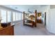 Spacious bedroom with four-poster bed, shuttered windows, and ample natural light at 618 Steep Canyon Ave, Las Vegas, NV 89183