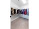 Functional walk-in closet featuring ample hanging space and neutral carpeting at 618 Steep Canyon Ave, Las Vegas, NV 89183