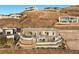 Impressive property featuring multi-level patios, outdoor living areas, and panoramic hillside views at 629 Majestic Rim Dr, Henderson, NV 89012