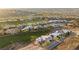 Expansive aerial view of a luxury community on a golf course, with modern homes and scenic desert landscape at 629 Majestic Rim Dr, Henderson, NV 89012
