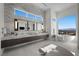Luxurious bathroom boasts marble accents, sleek vanity, and soaking tub with views of the surrounding mountains at 629 Majestic Rim Dr, Henderson, NV 89012