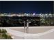 Luxurious bathtub overlooking a stunning city skyline at night, providing a serene and captivating experience at 629 Majestic Rim Dr, Henderson, NV 89012