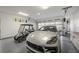 Spacious garage featuring epoxy floors, ample lighting, and room for a car and golf cart at 629 Majestic Rim Dr, Henderson, NV 89012