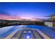 Beautiful infinity pool and spa offering breathtaking panoramic views of the city skyline at dusk at 629 Majestic Rim Dr, Henderson, NV 89012
