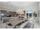 Open-concept kitchen and dining area with island seating, pendant lighting, and mountain views at 629 Majestic Rim Dr, Henderson, NV 89012