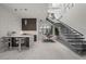 Open-concept living space with a modern bar, staircase, and ample seating for entertaining guests at 629 Majestic Rim Dr, Henderson, NV 89012