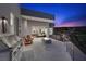 Charming outdoor patio with a fire pit and grilling area, opening to a serene bedroom at 629 Majestic Rim Dr, Henderson, NV 89012