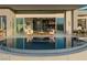Beautiful pool area with outdoor seating, seamlessly blending indoor and outdoor living spaces with city views at 629 Majestic Rim Dr, Henderson, NV 89012