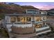 Impressive home with a pool, multiple balconies, and outdoor seating areas built into a hillside at 629 Majestic Rim Dr, Henderson, NV 89012
