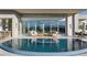 Inviting backyard pool area with comfortable lounge seating and scenic mountain views at 629 Majestic Rim Dr, Henderson, NV 89012