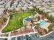 Aerial view of neighborhood park, pool, and recreation area amidst a vibrant community at 6325 Snap Ridge St # 102, North Las Vegas, NV 89081
