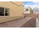 Enclosed backyard with low maintenance landscaping and brick-paved patio at 6325 Snap Ridge St # 102, North Las Vegas, NV 89081