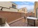 Cozy brick-paved backyard with a grill and seating area at 6325 Snap Ridge St # 102, North Las Vegas, NV 89081