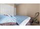Bedroom with neutral walls and carpet, features sliding closet doors at 6325 Snap Ridge St # 102, North Las Vegas, NV 89081