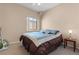 Bedroom featuring a carpeted floor, window, and a side table with lamp at 6325 Snap Ridge St # 102, North Las Vegas, NV 89081