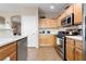Well-lit kitchen equipped with stainless steel appliances and tile flooring at 6325 Snap Ridge St # 102, North Las Vegas, NV 89081