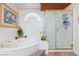 Bright bathroom featuring a soaking tub and glass-enclosed shower at 6578 Chimes Tower Ave, Las Vegas, NV 89139