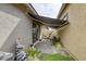 Backyard with stone water feature and a partially extended awning over the patio at 762 Lilac Oak St, Henderson, NV 89011