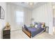 Stylish bedroom with modern chandelier, neutral carpet and a comfortable bed with accent pillows at 762 Lilac Oak St, Henderson, NV 89011