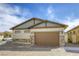 Beautiful home exterior featuring a spacious garage and well-maintained lawn at 762 Lilac Oak St, Henderson, NV 89011