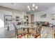Modern kitchen with white cabinets, stainless steel appliances, quartz countertop, and adjacent dining area at 762 Lilac Oak St, Henderson, NV 89011