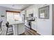 Beautiful kitchen boasting white cabinetry, stainless appliances, and a breakfast bar with wood laminate flooring at 762 Lilac Oak St, Henderson, NV 89011