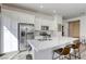 Stylish kitchen featuring white cabinets, stainless steel appliances, a large center island and quartz countertops at 762 Lilac Oak St, Henderson, NV 89011